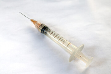 Close-up photo of a medical syringe with needle on white background. Perfect for healthcare,...