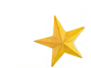 A gold star on a white background. Handcraft ornament of a gold glitter painted star made from...
