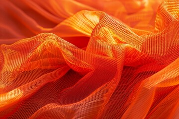 An intense orange mesh fabric displays intricate folds and textures, showcasing a vibrant and dynamic composition.
