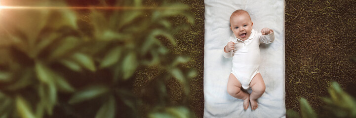 Happy Baby Lying on Blanket in Wide Banner