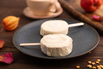 Сhocolate Ice cream in white glaze, cup of coffee, on brown wooden, side view, close up, selective...