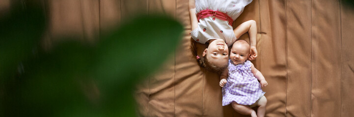Sisters Lying on Bed, Wide Banner with Copy Space