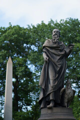 A Weathered Statue of a Man with a Book