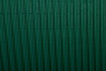 A vibrant green corrugated surface with a ribbed texture, perfect for use as an abstract background.
