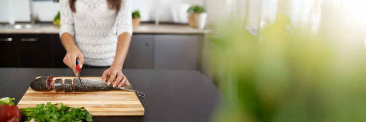 Cutting Fish in Kitchen with Copy Space Wide Banner