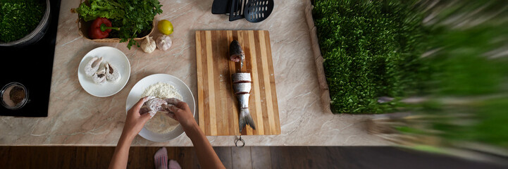 Preparing Fish in Kitchen Wide Banner with Copy Space
