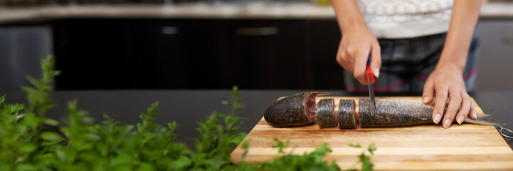 Chef Slicing Fish on Wooden Board with Copy Space Wide Banner