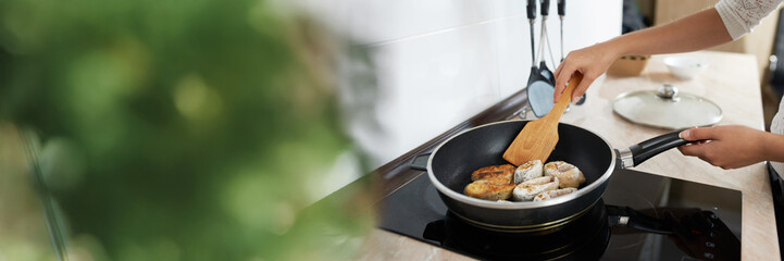 Cooking Fish on Stove Wide Banner with Copy Space