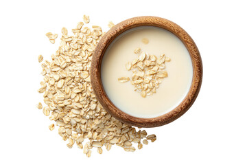 Wooden bowl of oat milk atop a bed of whole oats