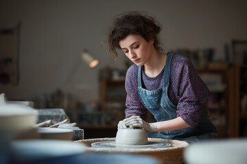 Creative Potter Shaping Clay in Art Studio