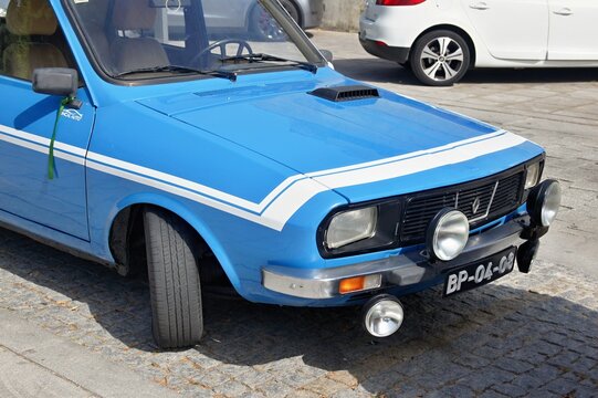 Renault 12 parked on a cobblestone street is showing its front and side
