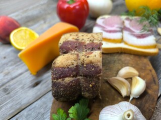 slices of dried meat lying on slices of bread . High-quality photo