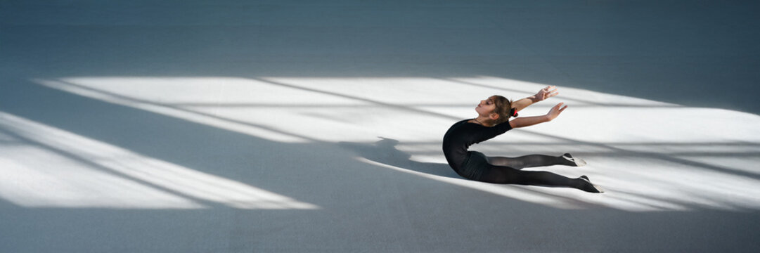 Graceful Gymnast Stretching on Floor Wide Banner - Powered by Adobe