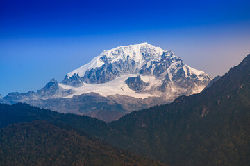 Fototapeta premium Beautiful first light from sunrise on Mount Pandim, at an elevation of 6,691 m , 21,952 ft above sea level. Himalayan mountain range, Sikkim, India. Sikkim is popular for tourists from all over India.