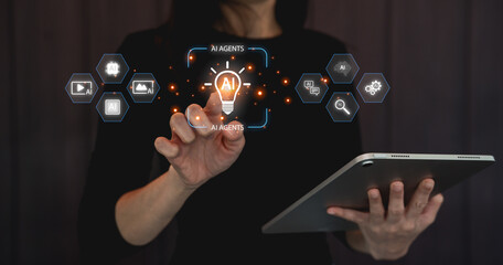 A person interacts with an interface displaying AI agents and icons while holding a tablet, suggesting advanced technology and digital innovation.