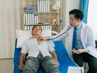 Image of a doctor examining a patient with a stethoscope to listen to the heartbeat of a male...