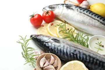 Fresh raw mackerels and spices on white table, closeup. Seafood delicacies