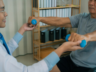 Asian physical therapist and elderly patient in wheelchair holding weightlifting belt. Health care...