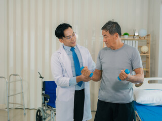 Asian physical therapist and elderly patient in wheelchair holding weightlifting belt. Health care...