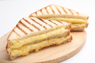 Tasty sandwiches with melted cheese on white table, closeup