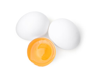 Whole and broken chicken eggs isolated on white, top view