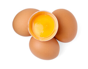 Whole and broken chicken eggs isolated on white, top view