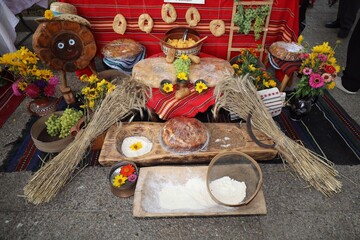 Freshly baked homemade bread arranged in traditional Bulgarian textiles. Image of some tasty Home-made bakery products. Fresh bread,brown, wheat, sliced, round, product, bagel, delicious, baking.