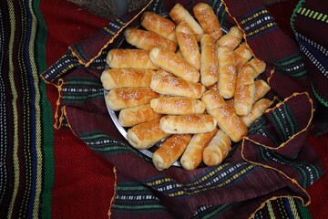 Freshly baked homemade bread arranged in traditional Bulgarian textiles. Image of some tasty...