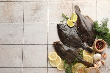 Seafood. Fresh raw flounder fish and spices on light tiled table, flat lay. Space for text