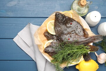 Fresh raw flounder fish and spices on blue wooden table, flat lay. Seafood