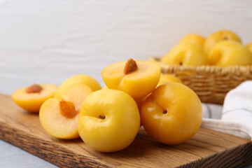 Ripe yellow cherry plums on grey table, closeup