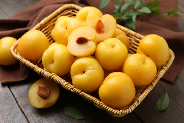 Ripe yellow cherry plums on wooden table, closeup