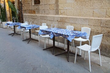 Sidewalk restaurant tables in Syracuse, Italy