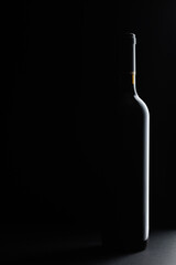 Red wine bottle silhouette over black background.