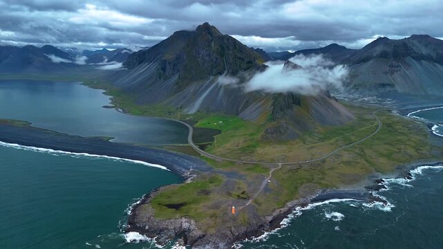 Hvalnes Iceland with sweeping views of rugged mountains, lush greenery, and the tranquil coastline. Natures artistry is on full display amidst the captivating landscape.