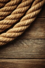 Fototapeta premium Close-up of Thick Brown Rope on Rustic Wooden Surface, Overhead Shot, Nautical Theme, Maritime Decor, Country Style, Textured Background