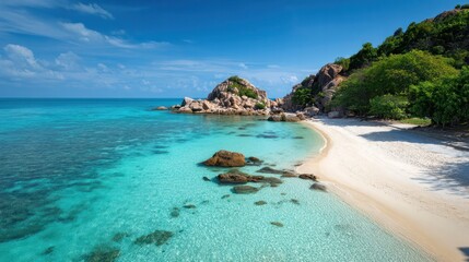 Fototapeta premium Seashore Oasis: This captivating shot captures the serenity of a tropical seashore, featuring a tranquil bay with crystal-clear, azure water gently lapping a pristine sandy beach.
