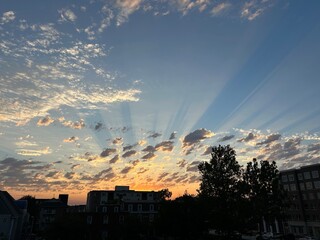 sunset over city with glowing rays