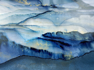 Abstract blue background with gold — fluid art texture made with alcohol ink and golden potal. Beautiful smudge and stains. Blue with purple natural art backdrop resembles watercolor or aquarelle.
