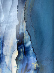 Abstract blue background with gold — fluid art texture made with alcohol ink and golden potal. Beautiful smudge and stains. Blue with purple natural art backdrop resembles watercolor or aquarelle.