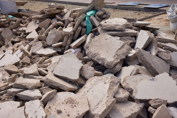There are numerous piles of concrete debris observable at the busy construction site right now