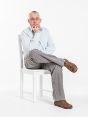 Genuine Interest. Eye contact from a middle-aged man  with his hand on his chin listening in...
