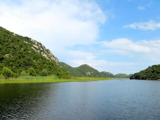 Expansive Views of Skadar Lake and Its Lush Surroundings in Montenegro Under a Serene Sky