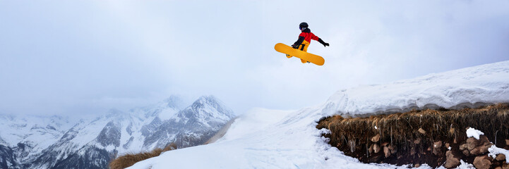 Snowboarder Jumping High in Mountain Wide Banner