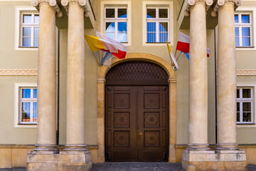 Entrance to a building on Ostrów Tumski in Wrocław, decorated with four columns, wooden doors,...
