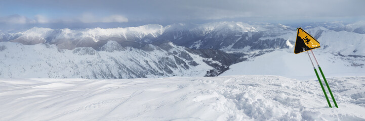Obraz premium Snowy Mountain Landscape with Warning Sign, Wide Banner