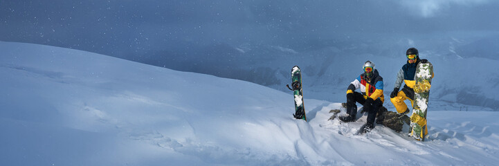 Snowboarders on Snowy Mountain Wide Banner