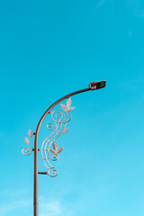 Street lamp on blue sky background. Unique street lights in the city.