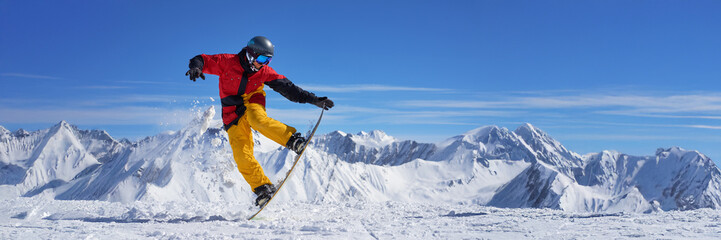 Snowboarder Jumping in Mountain Landscape Wide Banner