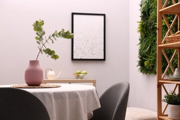 Stylish table with chairs and decor in dining room. Interior design
